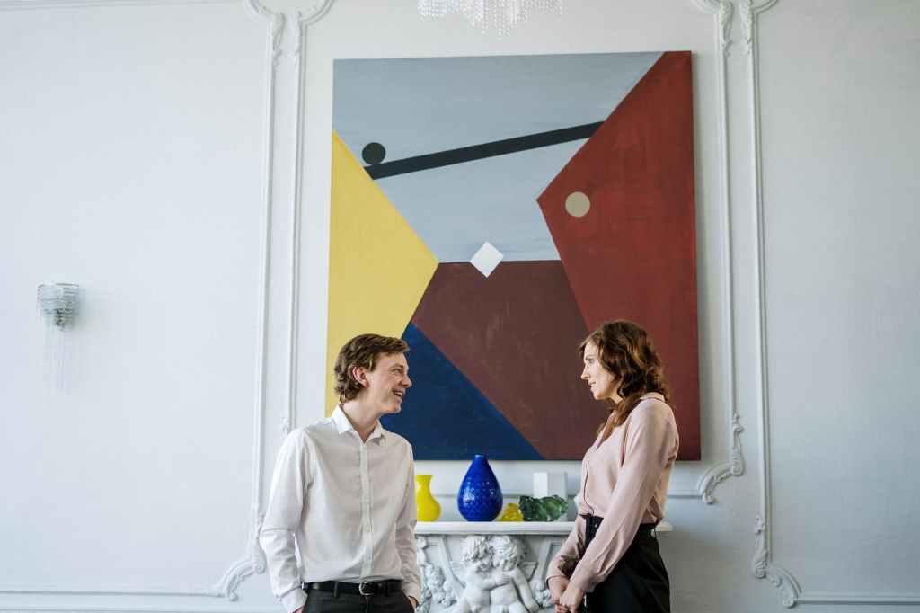 woman in white long sleeve shirt standing beside woman in white long sleeve shirt